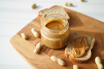 Peanut Butter Jar and Sandwich on a Wooden Board Still Life
