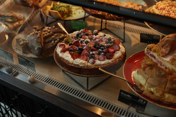 Delicious strawberry and blueberry cream cake displayed 