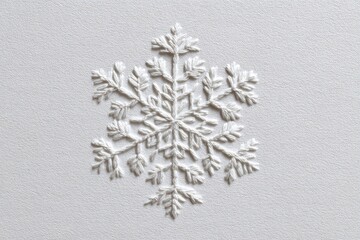 Detailed embossed snowflake design on off-white background