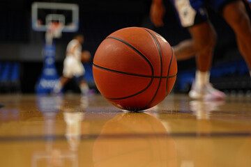 Basketball on a Gleaming Hardwood Court Ready for Action