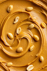 Creamy Peanut Butter Swirl with Scattered Whole and Halved Peanuts Close Up
