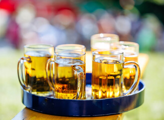 Tray of refreshing cold draft beers with bright bokeh background