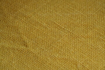 Yellow bfabric canvas burlap  urlap fabric texture – close-up background top view 