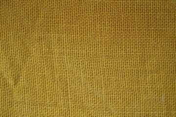 Yellow bfabric canvas burlap  urlap fabric texture – close-up background top view 