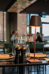 Elegant restaurant table setting with modern lamp.