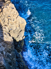 Roks and mountains from drone wives. Rocky beach and green islands seen from above. Aerial view on frozrn river in forest landscape in winter season. Black white stone texture. Sea and rocks.