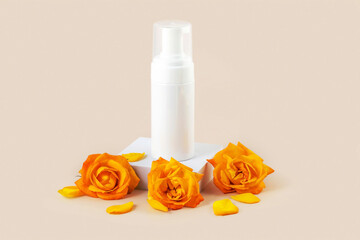a container for skin care products next to yellow rose buds on a beige background