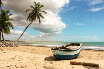 stunning coastal landscape featuring a rustic wooden boat resting on a sandy beach under a partly...