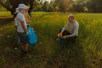 Volunteers collecting trash in a field during a cleanup event