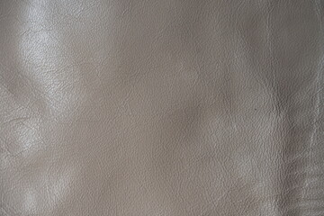 beige leather texture close-up, seams on leather jacket as background, beige natural leather as background, light brown leather stitching	
