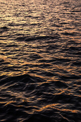 Orange sunset over the sea. Water surface