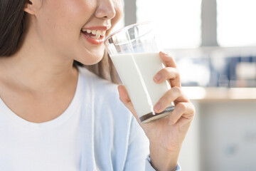 Close-up woman a glass of drink milk in the morning