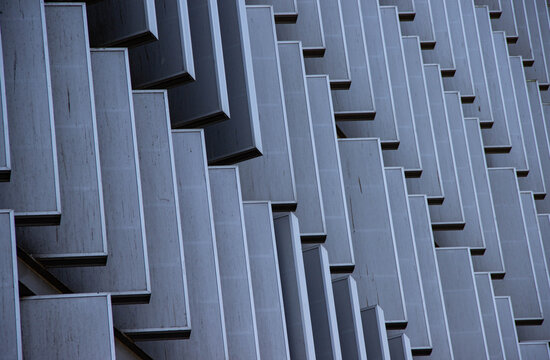 Abstract architectural detail showcasing a modern building facade with geometric patterns and textured surfaces, emphasizing innovative design and contemporary aesthetics - Powered by Adobe