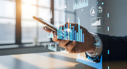 Business professional analyzing financial data on a tablet device with digital graphs and charts in a modern office setting for investment and technology themes