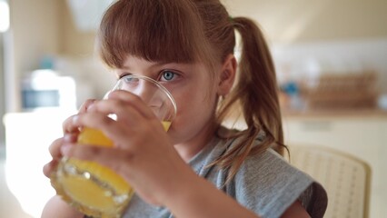 children drink juice. group of children drinking juice in the kitchen morning breakfast a before school. happy family kid dream concept. orange juice healthy food. lifestyle kids drink juice
