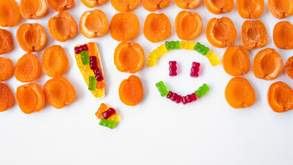 Bright candies and dried apricots form a playful smiley face design