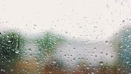 raindrop on the window in autumn a background. wet glass rain drops rainy sky blurred background close-up. rain in the window on the background of the sky lifestyle blurred plan