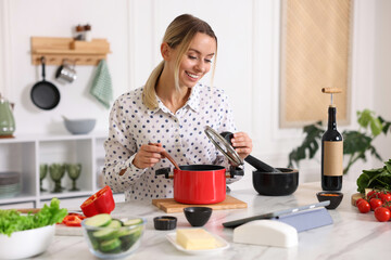 Smiling woman looking at recipe on tablet while cooking at table in kitchen