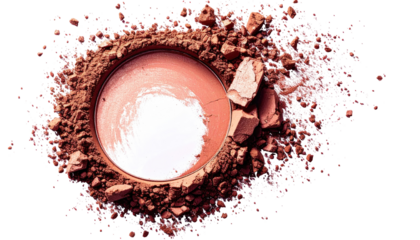 A circular blush compact with scattered powder