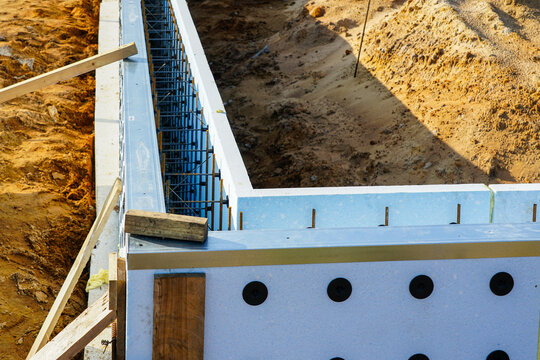 ICF foundation wall with visible rebar reinforcement during construction at modern building site