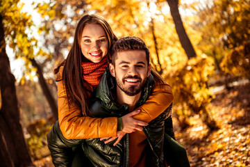 Autumn romance captured as a happy couple enjoys bonding during a beautiful sunny day in a park