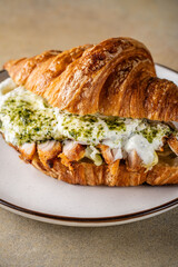 Croissant sandwich with chicken and creamy pesto filling