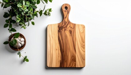 Wooden cutting board with garlic and potted plant.