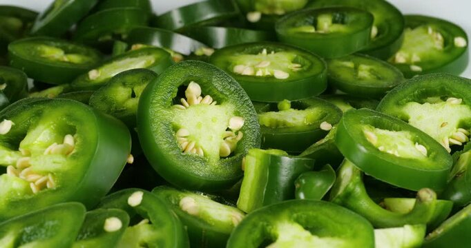 Green Jalapeno Chili Peppers Slices Food Rotate Footage. Close Up Background of Green Plants
