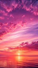 Obraz premium A breathtaking sunset paints the sky with vibrant hues of pink and purple over a calm ocean