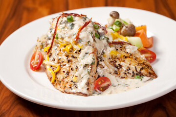 Close up of a chicken with rice on wood table