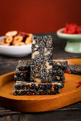 Homemade Black Sesame Walnut Energy Bars on Wooden Board - Healthy Nutritious Snack Food