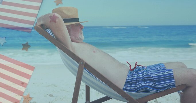 Lounging older man reclining on beach chair at shoreline, with striped swim trunks and straw fedora - Powered by Adobe