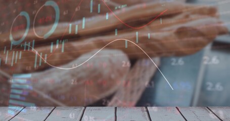 Showcasing wooden tabletop surface in kitchen with basket of baguettes and digital stock charts