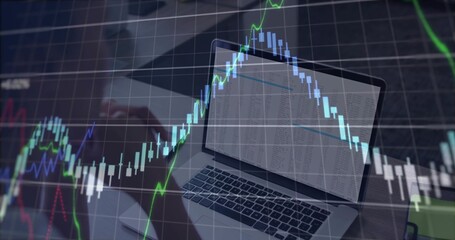 Fingers typing on laptop keyboard at office desk, with downward-trending candlestick chart overlay