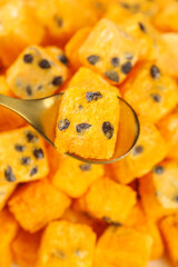 Freeze-dried passion fruit blocks on spoon - instant tea ingredient and healthy dried fruit snack