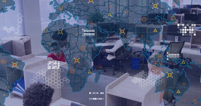 Collaborating team analyzing data at open?plan office, with dual monitors, world map overlay