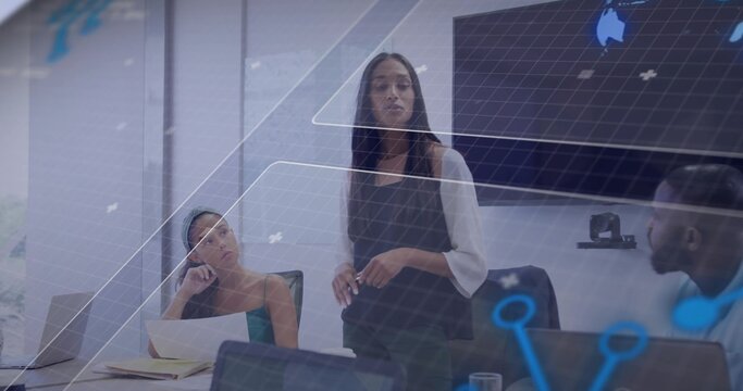 Business leader standing and presenting in office conference room, with laptops and virtual overlay