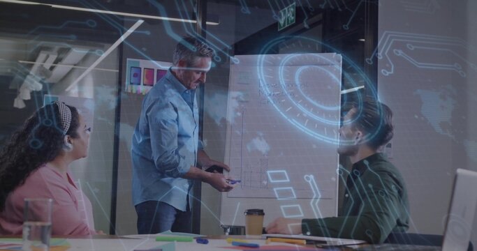 Presenting mature male wearing suit explaining strategy in business conference room, with flipchart - Powered by Adobe