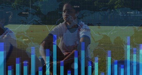 Lacing kneeling soccer player lacing cleat on grass field, with cones, shin guards and data overlay