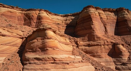 Fototapeta premium Stunning sandstone formations rise against a vibrant blue sky