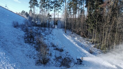 There are chair elevators on the slopes of the ski center. Skiers climb them. The snow cannon is...