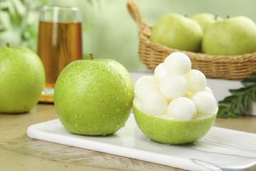 Fresh Green Apple and Pear Display with White Garnish Crown on Wooden Board
