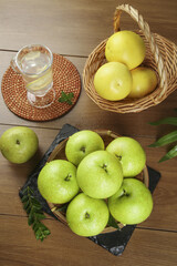 Fresh Green Apples and Lemons in Wicker Baskets on Wooden Table - Healthy Organic Fruit Still Life