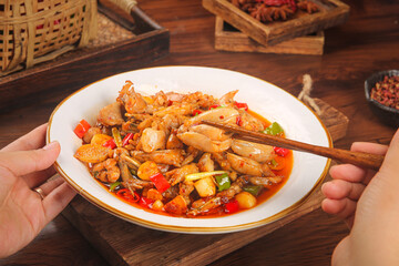 Spicy Stir-Fried Chicken and Beef Dish with Vegetables Served on Traditional Wooden Table