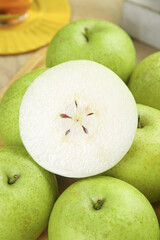 Fresh Green Pears with Sliced Half Showing Interior Seeds and White Flesh
