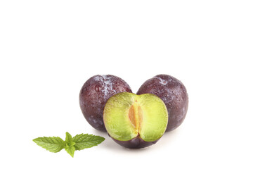 Fresh Sweet Plums Cut in Half with Mint on White Background - Healthy Fruit Display