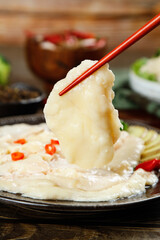Asian Hot Pot with Chicken and Red Chopsticks - Traditional Chinese Cuisine