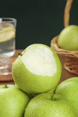Fresh Green Pears with Cut Pear Showing White Flesh in Rustic Kitchen Setting