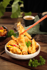 Spicy Marinated Chicken Claws Asian Appetizer with Chopsticks and Tea on Rustic Wood Table
