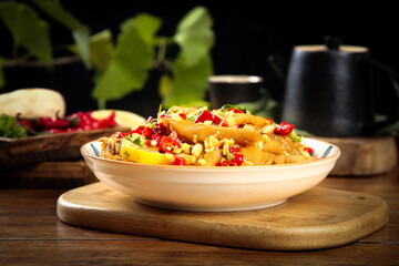 Spicy Fresh Chicken Bowl with Lemon Peppers and Herbs on Rustic Wooden Board